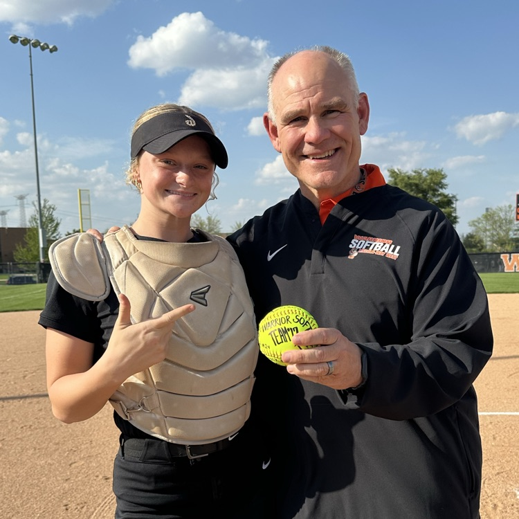 athlete and principal holding ball