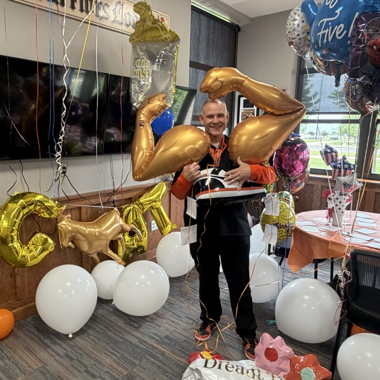 principal with balloons in office