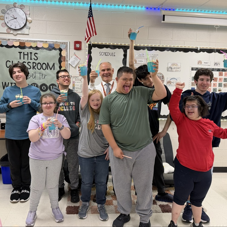 principal celebrating with students in classeroom
