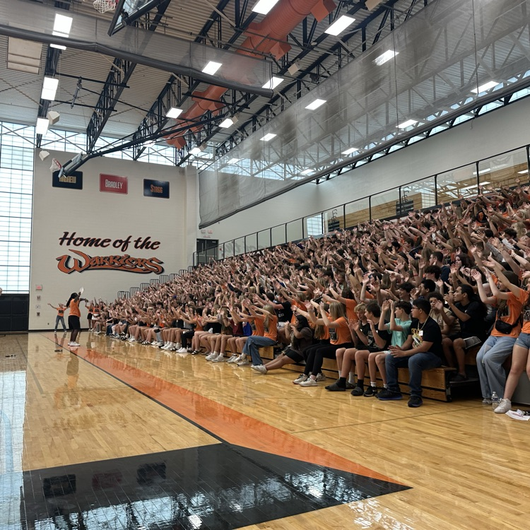 students in bleachers at assembly