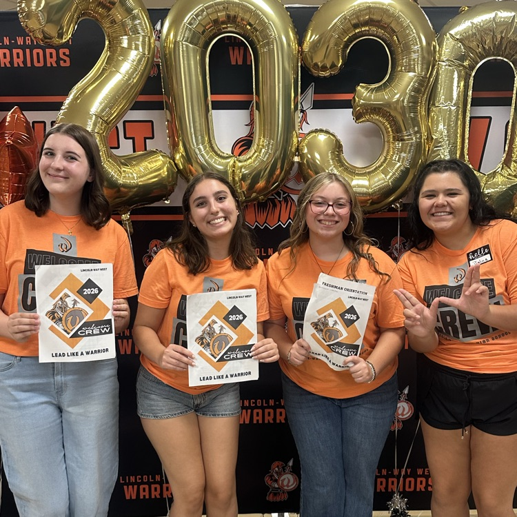 four students in front of 2030 balloons