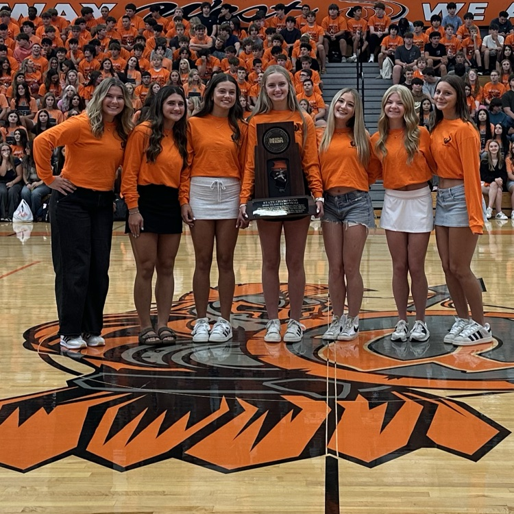 seven softball players with the state trophy