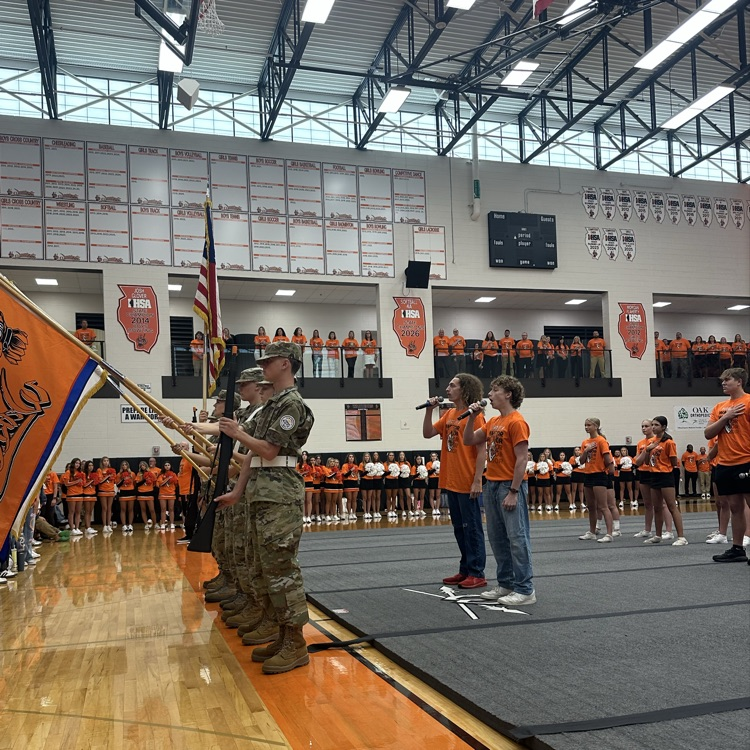 two students signing the national anthem during the assembly