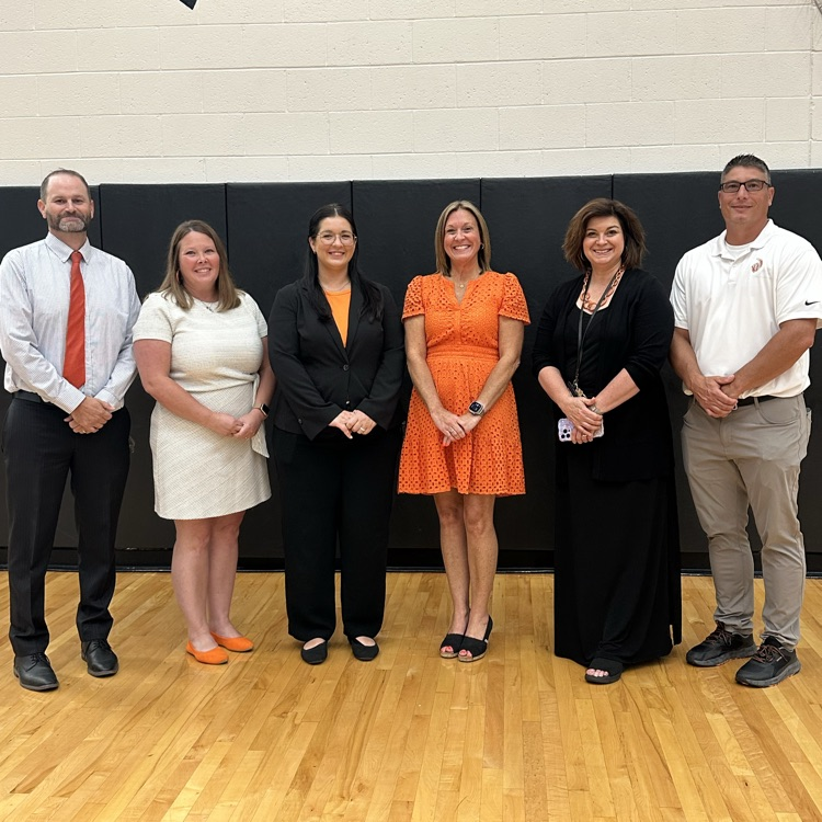 administrative team in gym prior to event