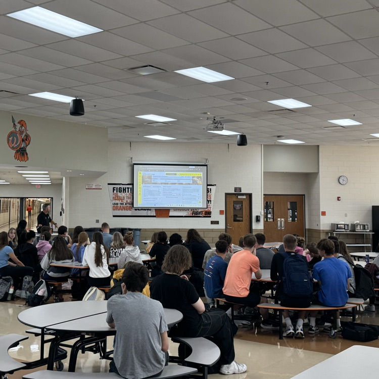 students in cafeteria at presentation