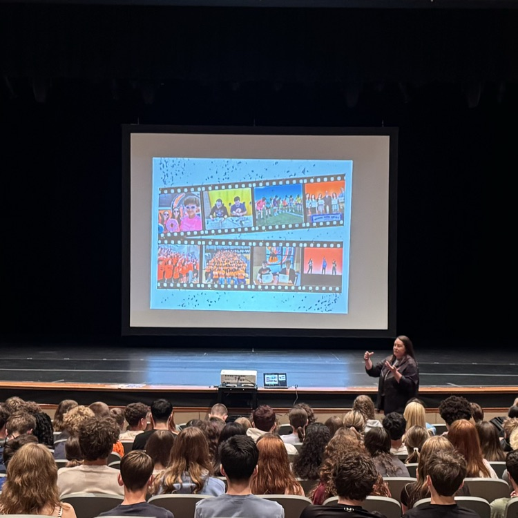 students in auditorium at presentation