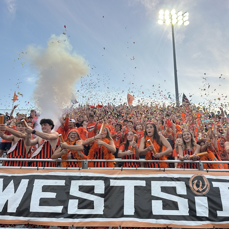 students celebrating at kickoff of the football game