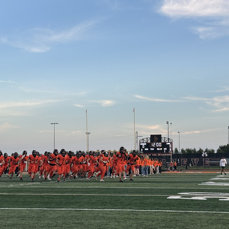football team running on the field