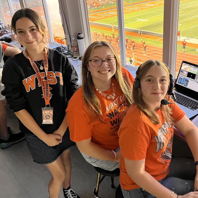 three students a part of the TV club in the press box