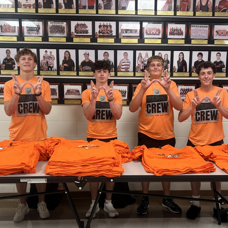 students helping pass out orange shirts