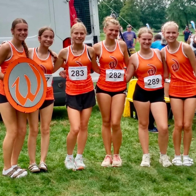cross country athletes posing for a photo at the race