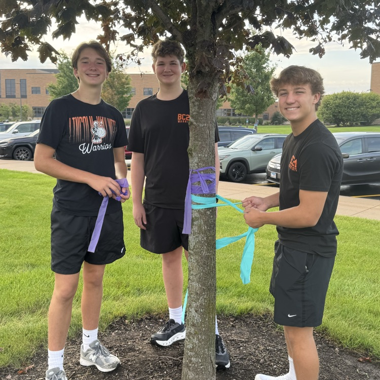 students posing for a photo with ribbon