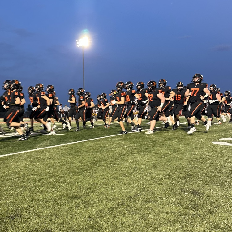 football players running on the field