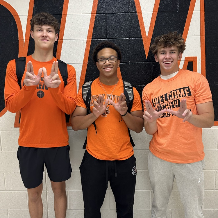 students wearing orange in the hallway