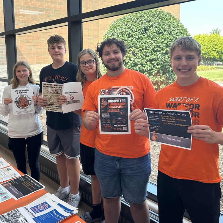 students holding activity flyers