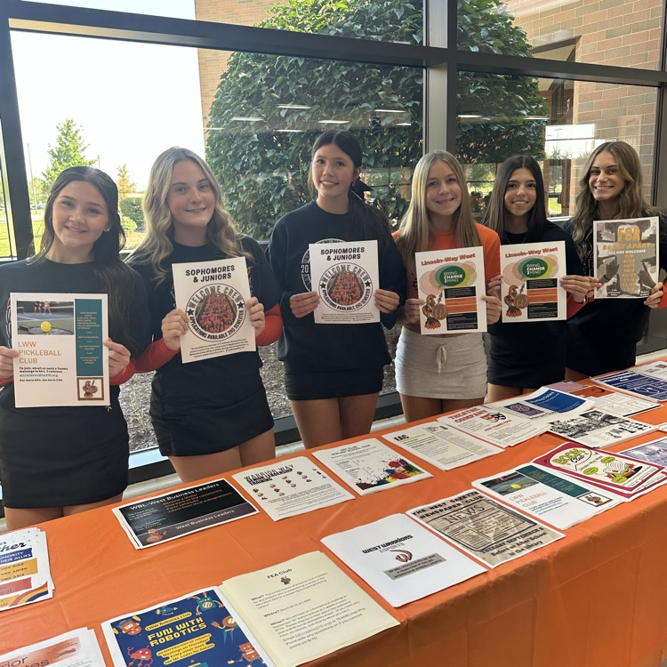 students holding activity flyers