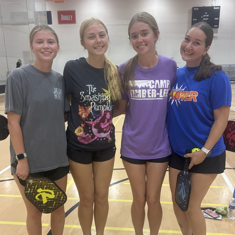 students at pickleball posing for a photo