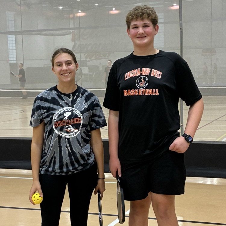 two students posing for a photo at pickleball