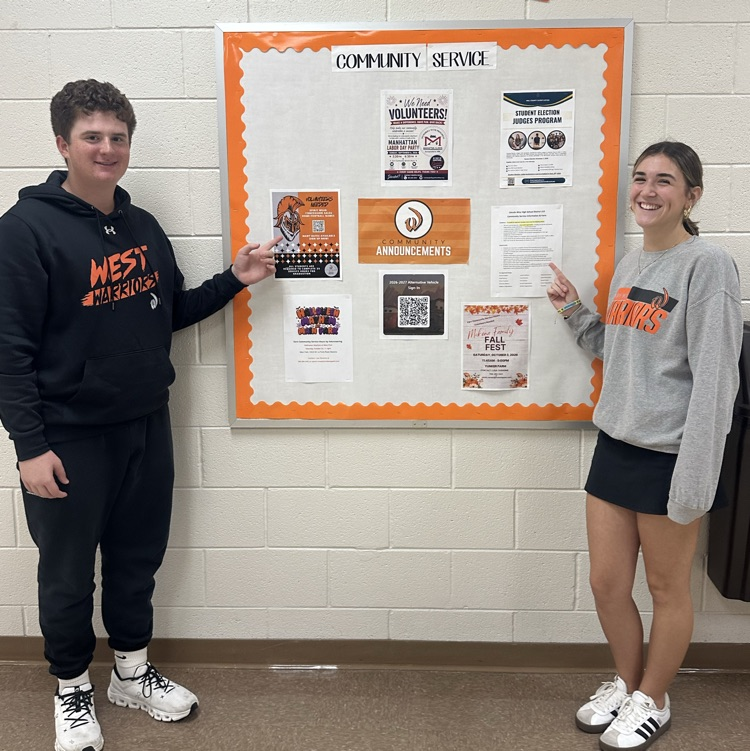 students standing in front of community service bulletin board