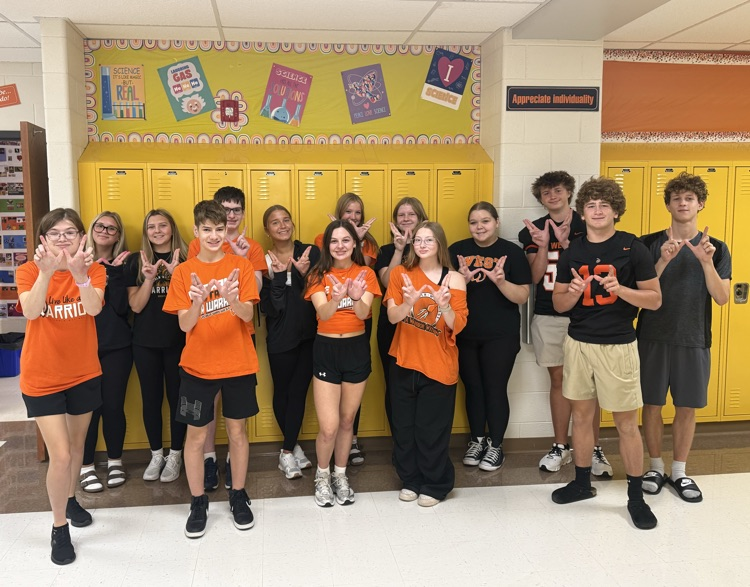 group of students wearing school spirit wear in the hallway