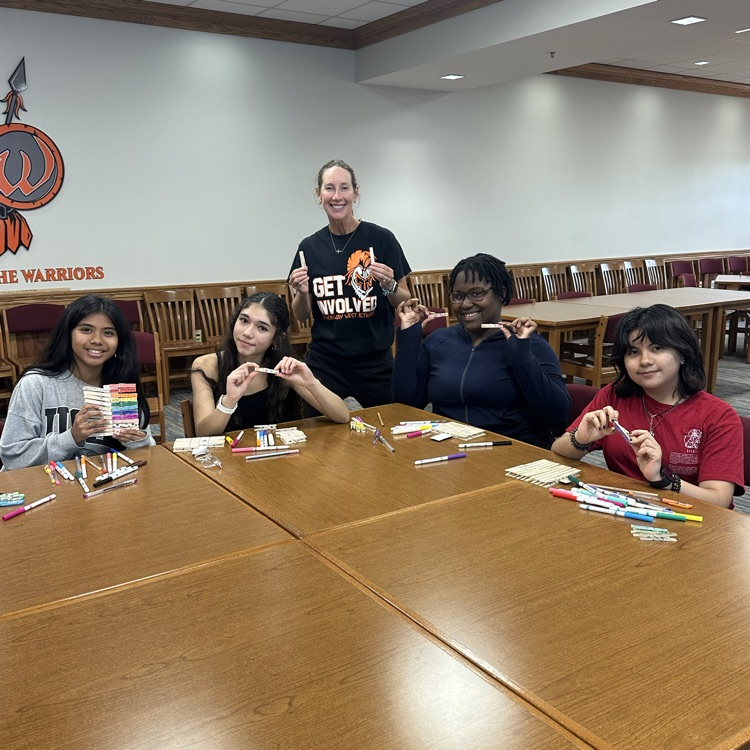 students working on kindness clips at club meeting