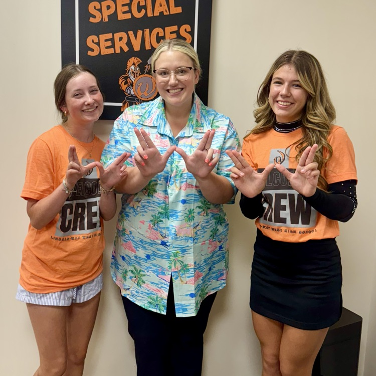 welcome crew members with staff members holding a W
