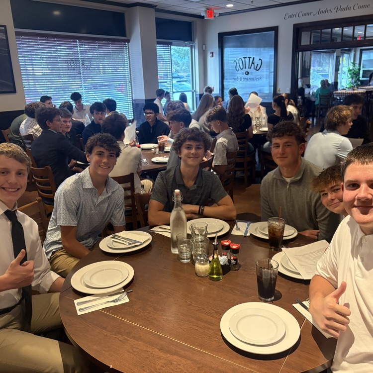 students posing for a photo at restaurant table
