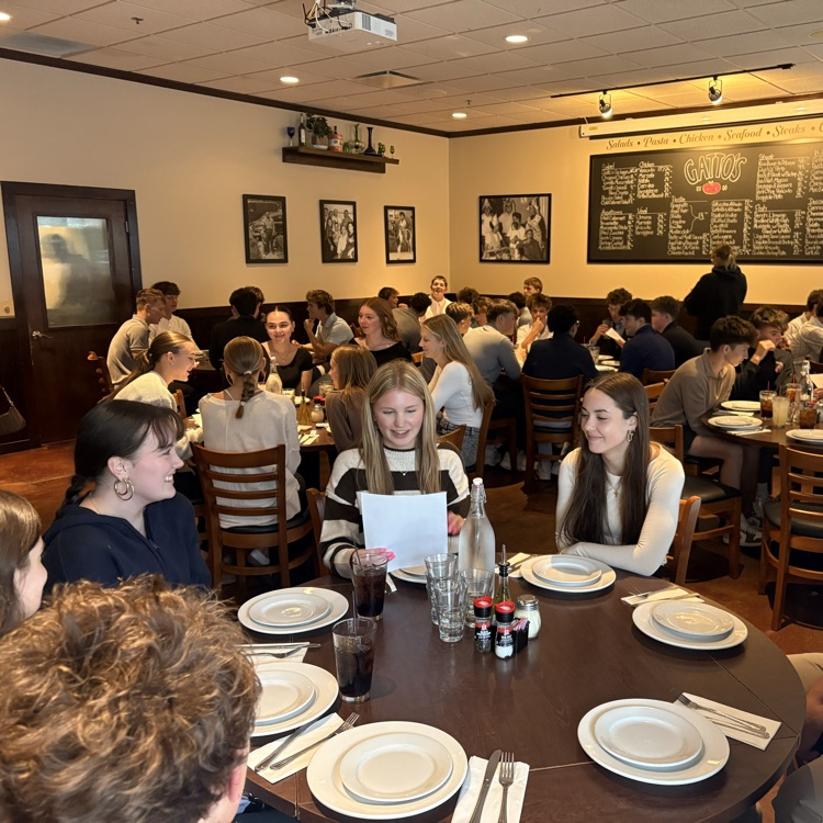 students conversing at restaurant tables