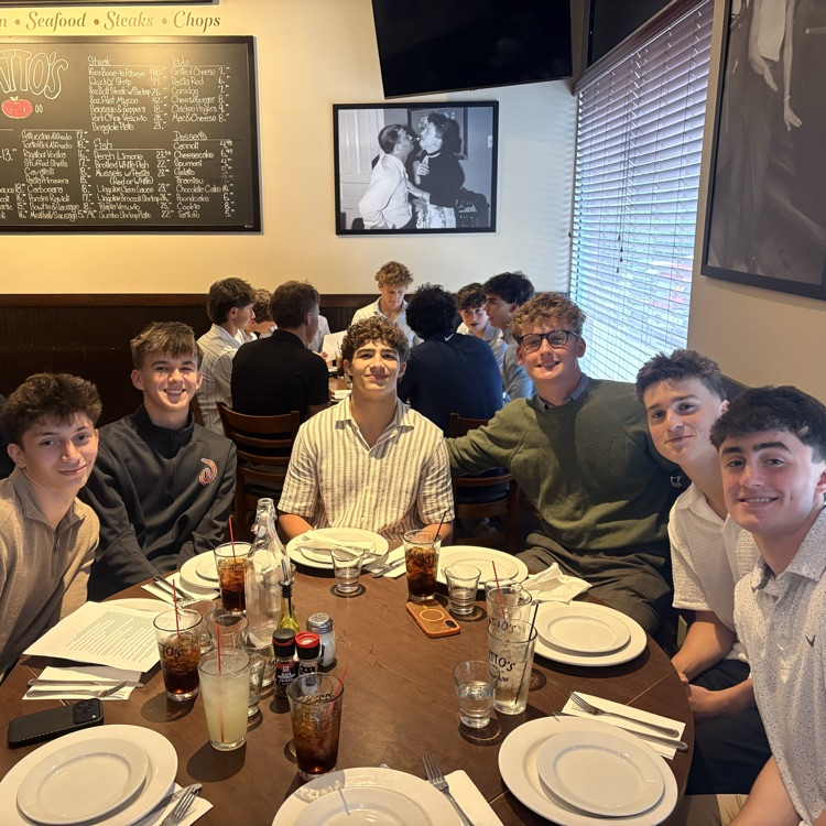 students posing for a photo at a restaurant