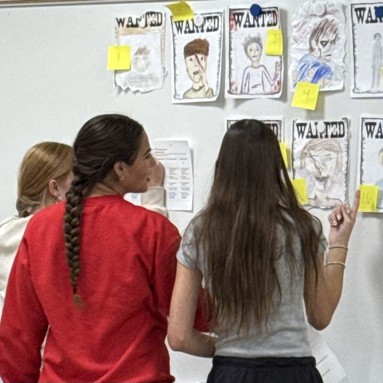 students looking at posters