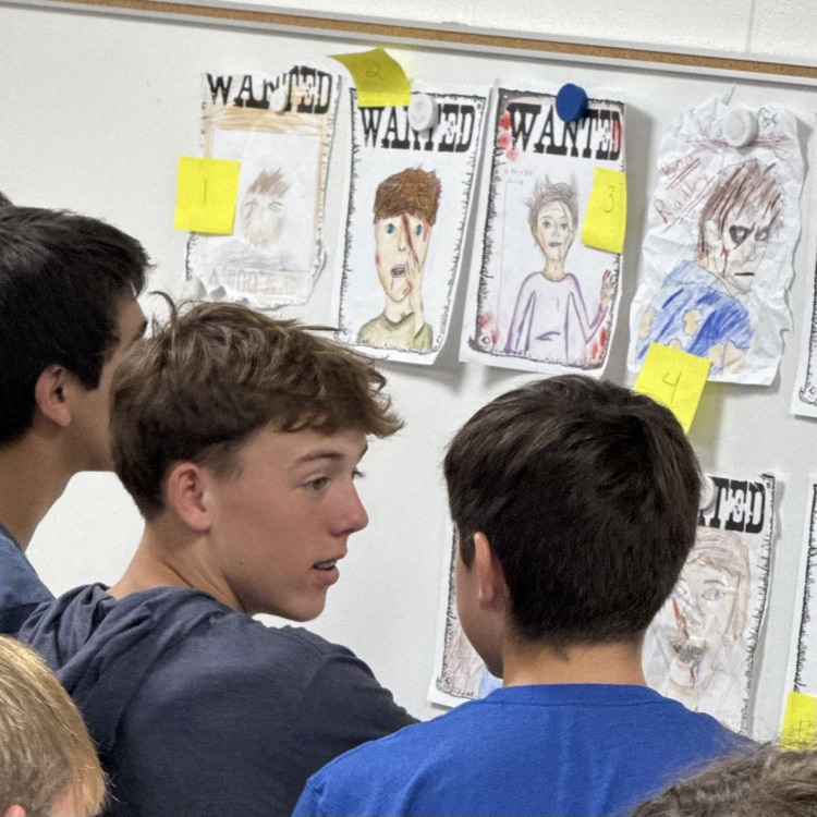 students looking at posters