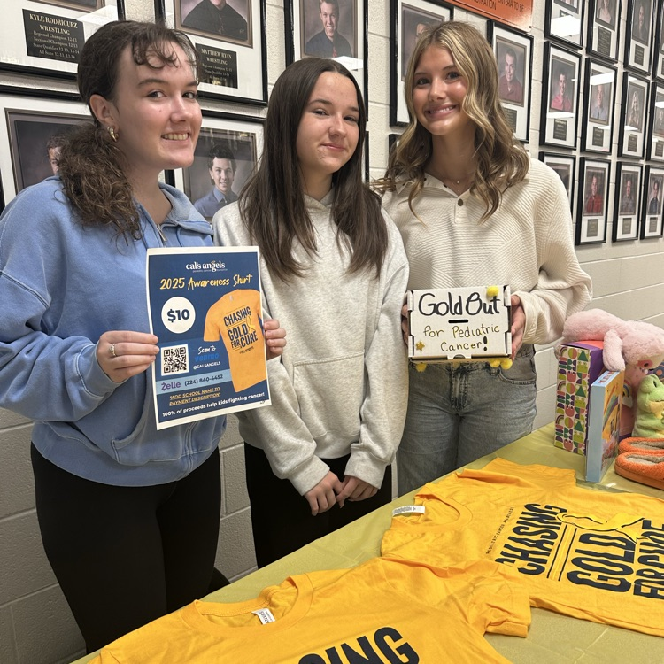 students holding gold out flyer and donation box