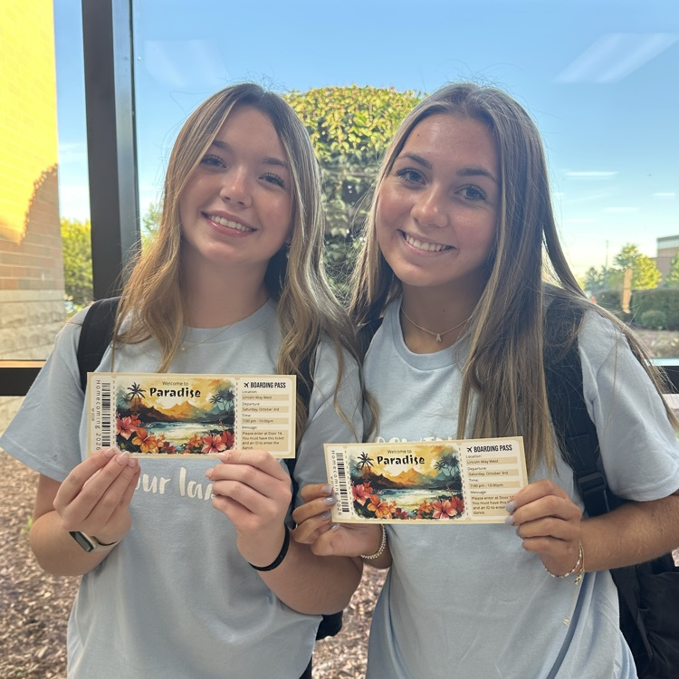 students holding dance tickets