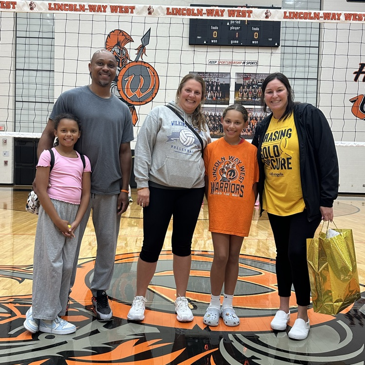 family and coach posing for a photo