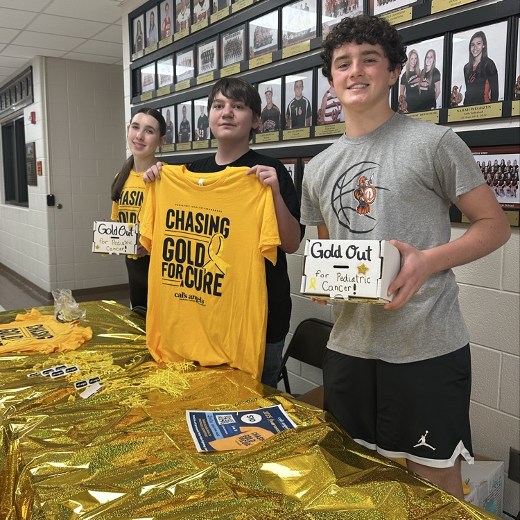 students helping at Goldout table