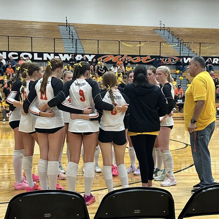 volleyball team in huddle