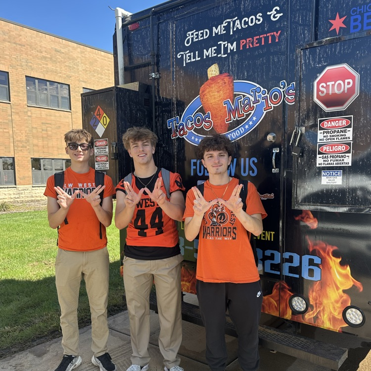 students in front of taco truck