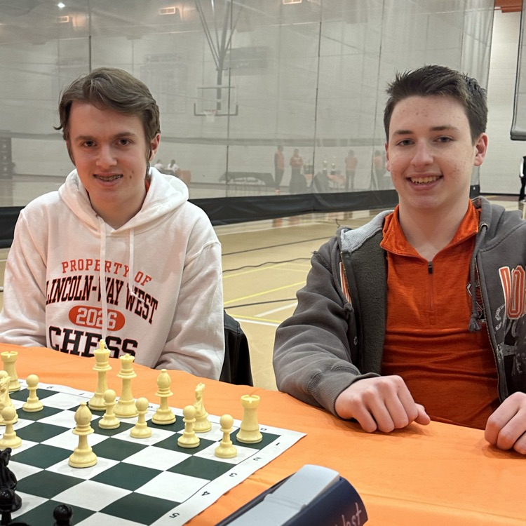 two students in front chess board