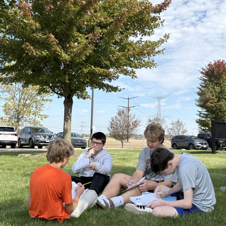 biology students studying under a tree