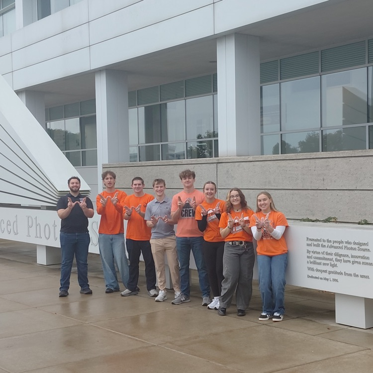 students in front of building