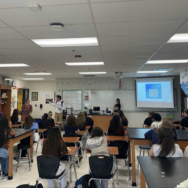 students in classroom listening to staff presentation