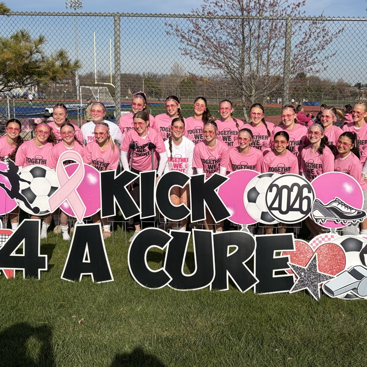 students behind kick for a cure sign