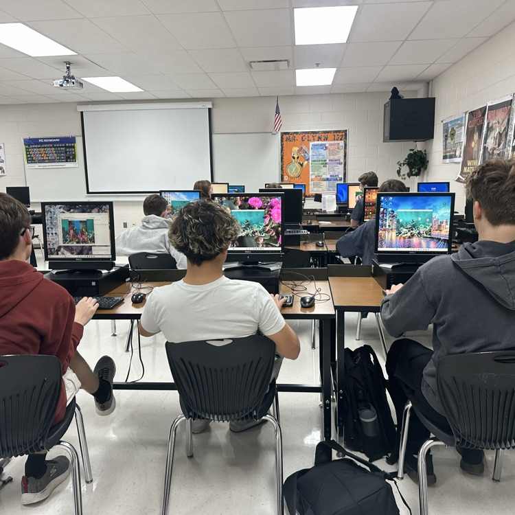 students in classroom working on computers