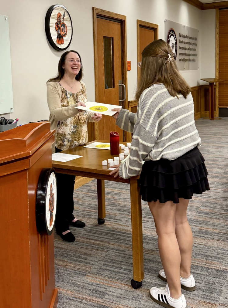 staff member handing student a certificate