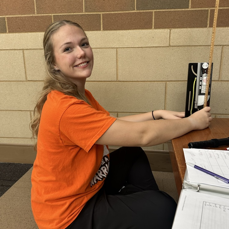 student completing lab results in the hallway
