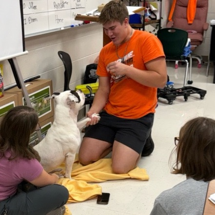 student interacting with animal