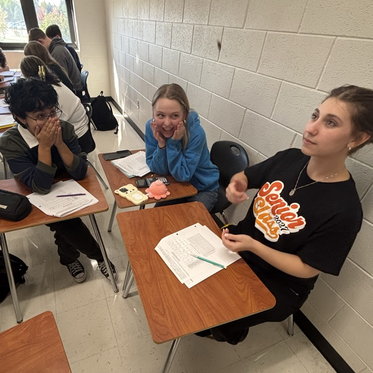 student flipping a coin as part of math classwork