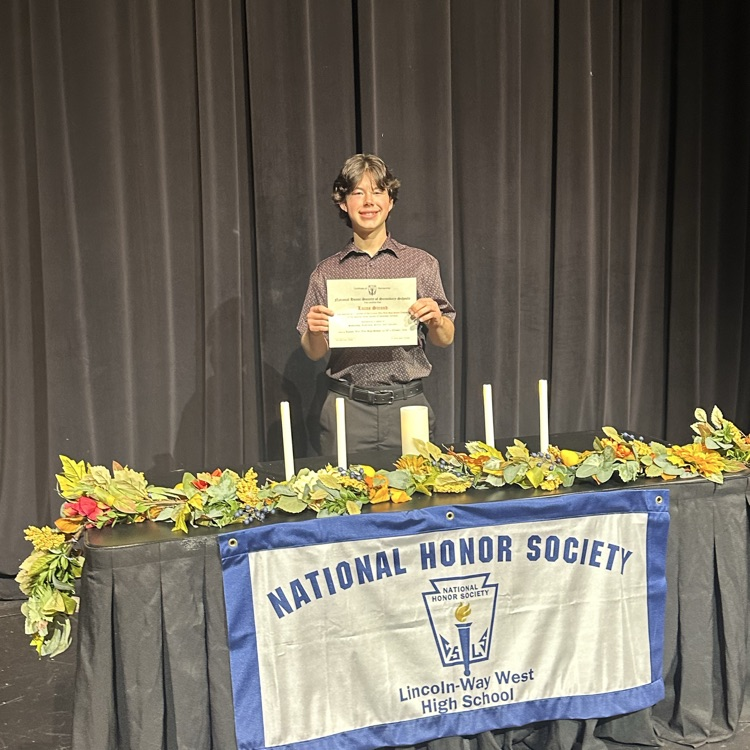 student taking photo at NHS table