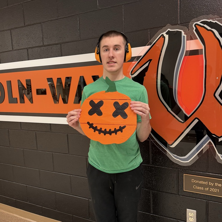 student showing their pumpkin project