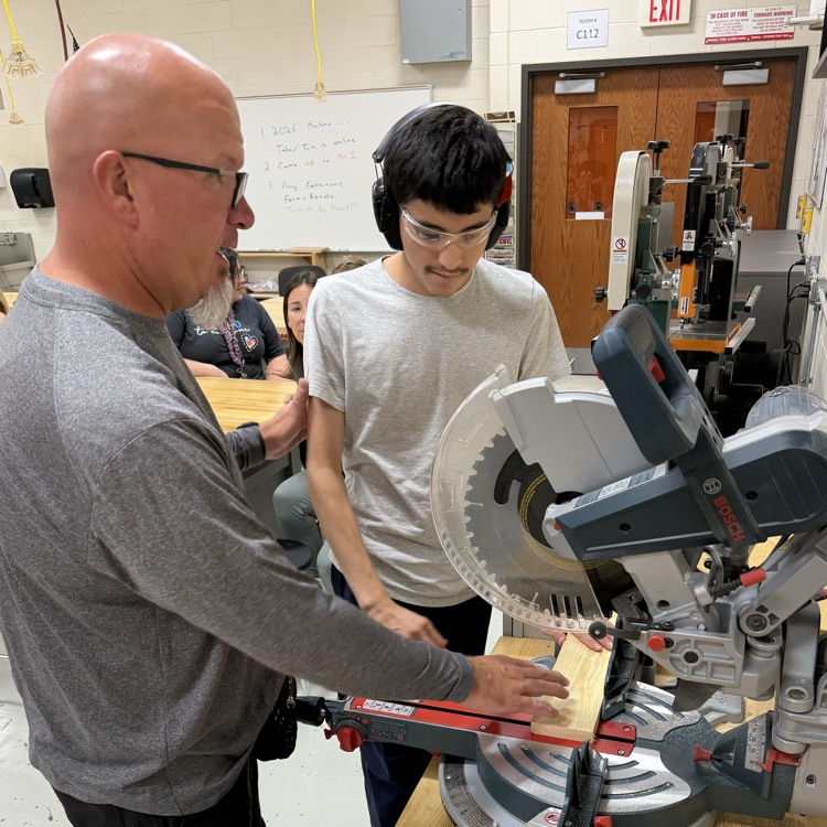 teacher and student working at equipment table